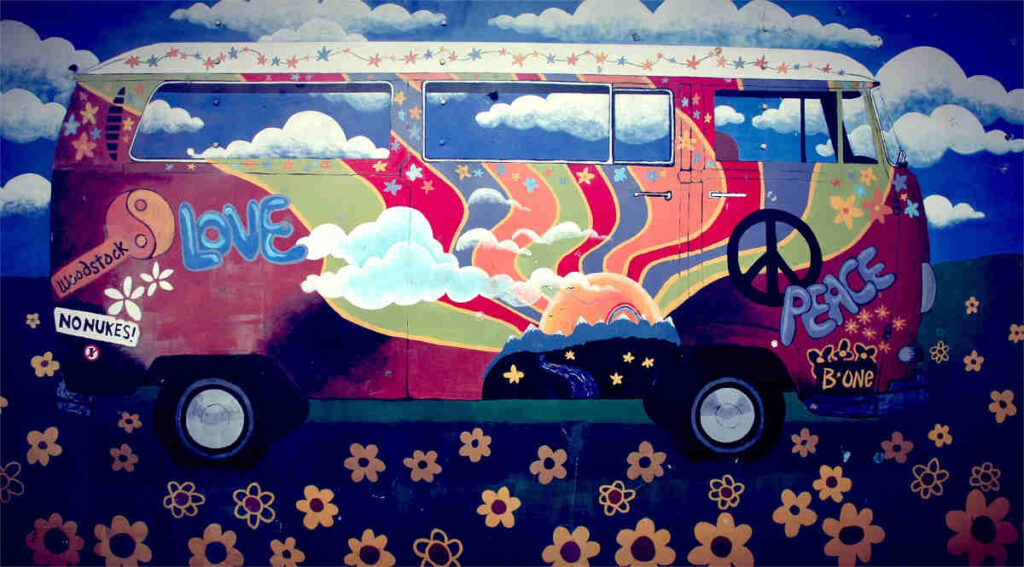 A "hippy"-era VW microbus, heavily adorned with graphics.